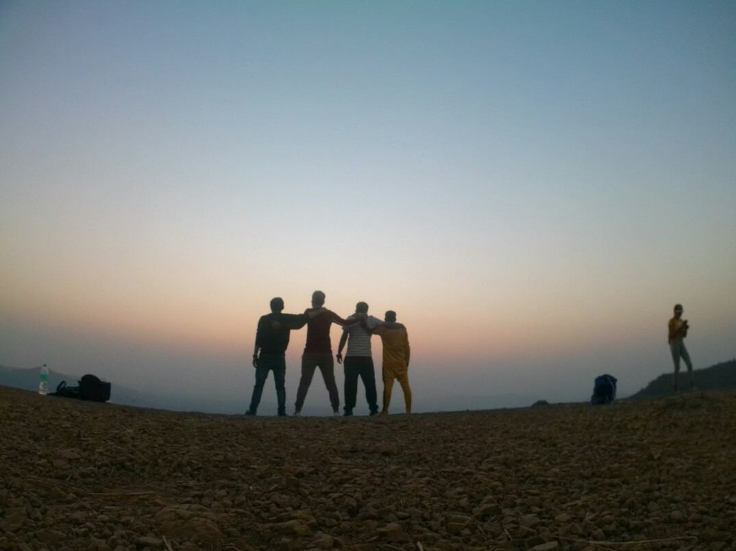Group portrait of four photojournalists standing together