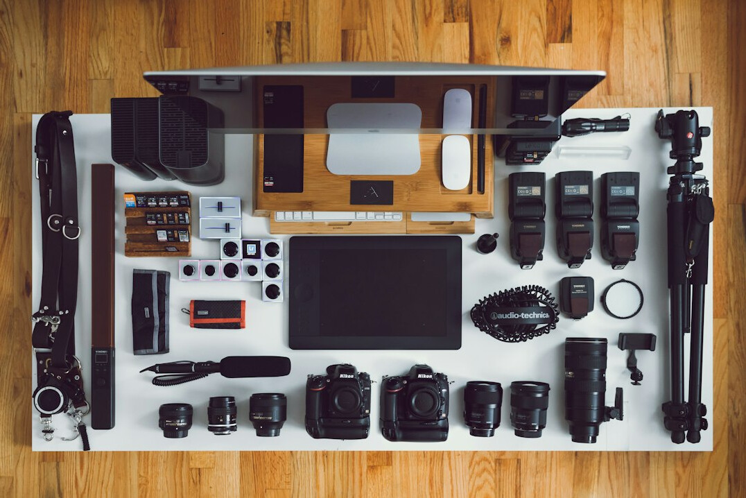 Notebook, camera and coffee cup on a studio desk