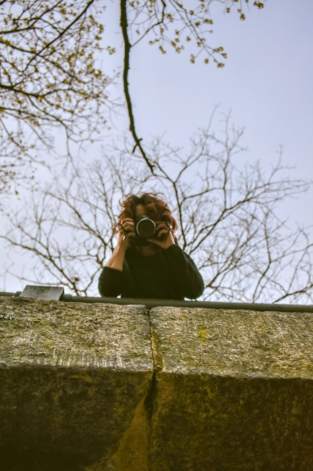 Documentary photographer holding a camera outdoors