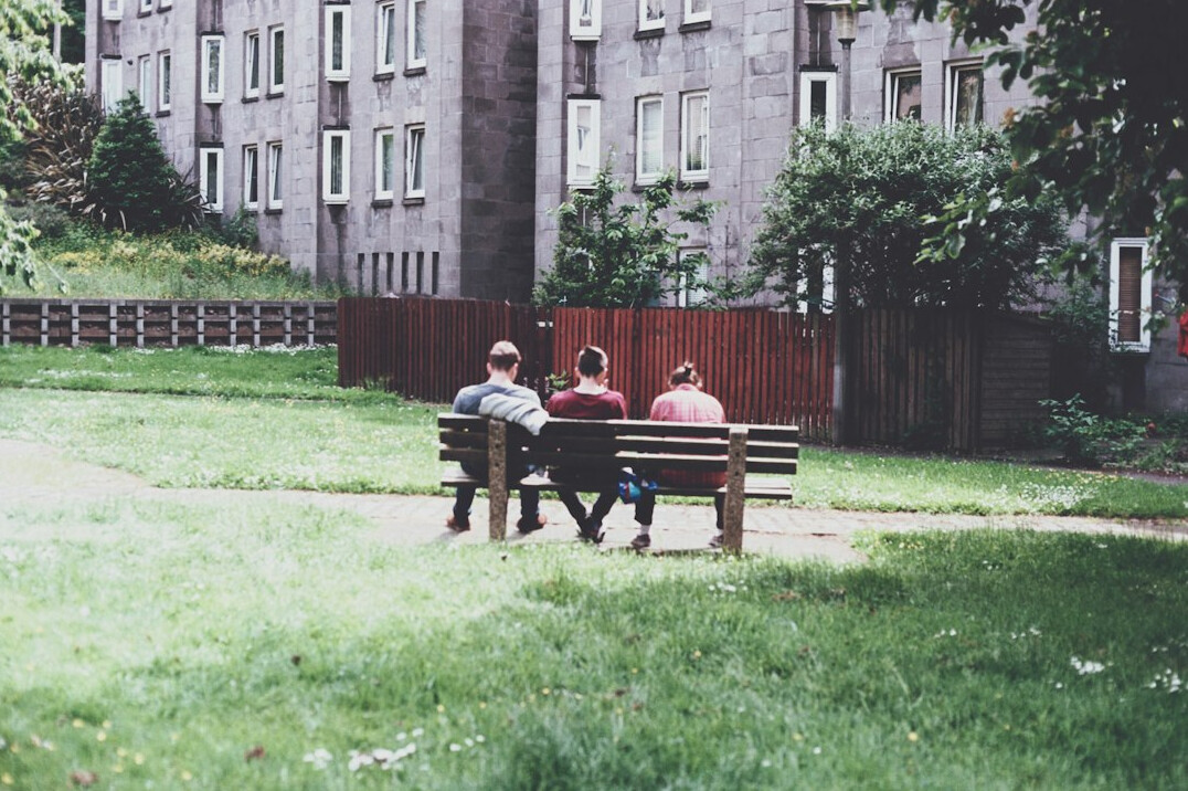 Courtyard of an old apartment block with residents talking
